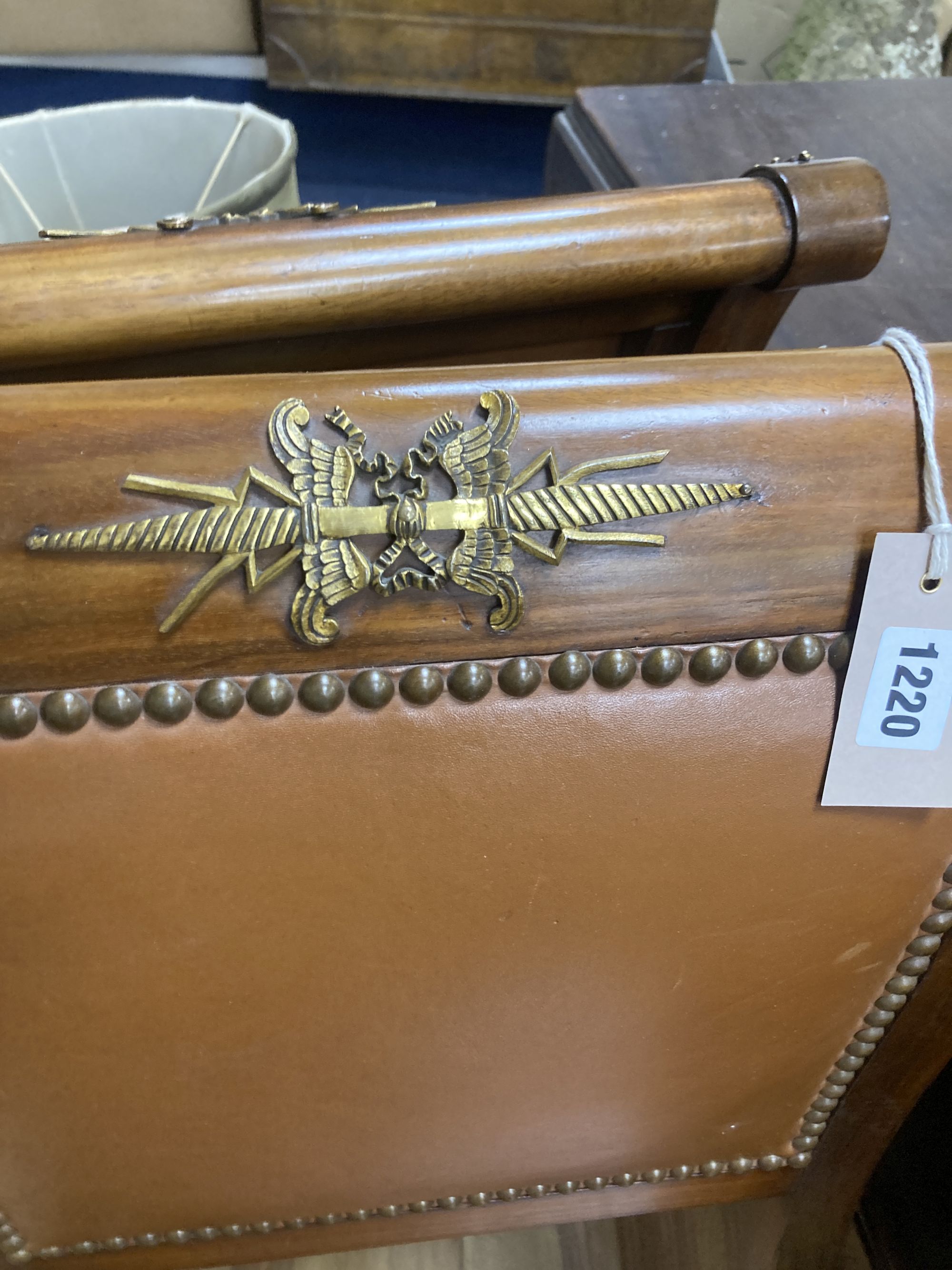 A set of six Empire style brass mounted mahogany dining chairs with tan leather upholstery